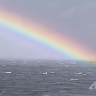 Экипаж судна на Курилах запечатлел фантастическую радугу над бушующим морем